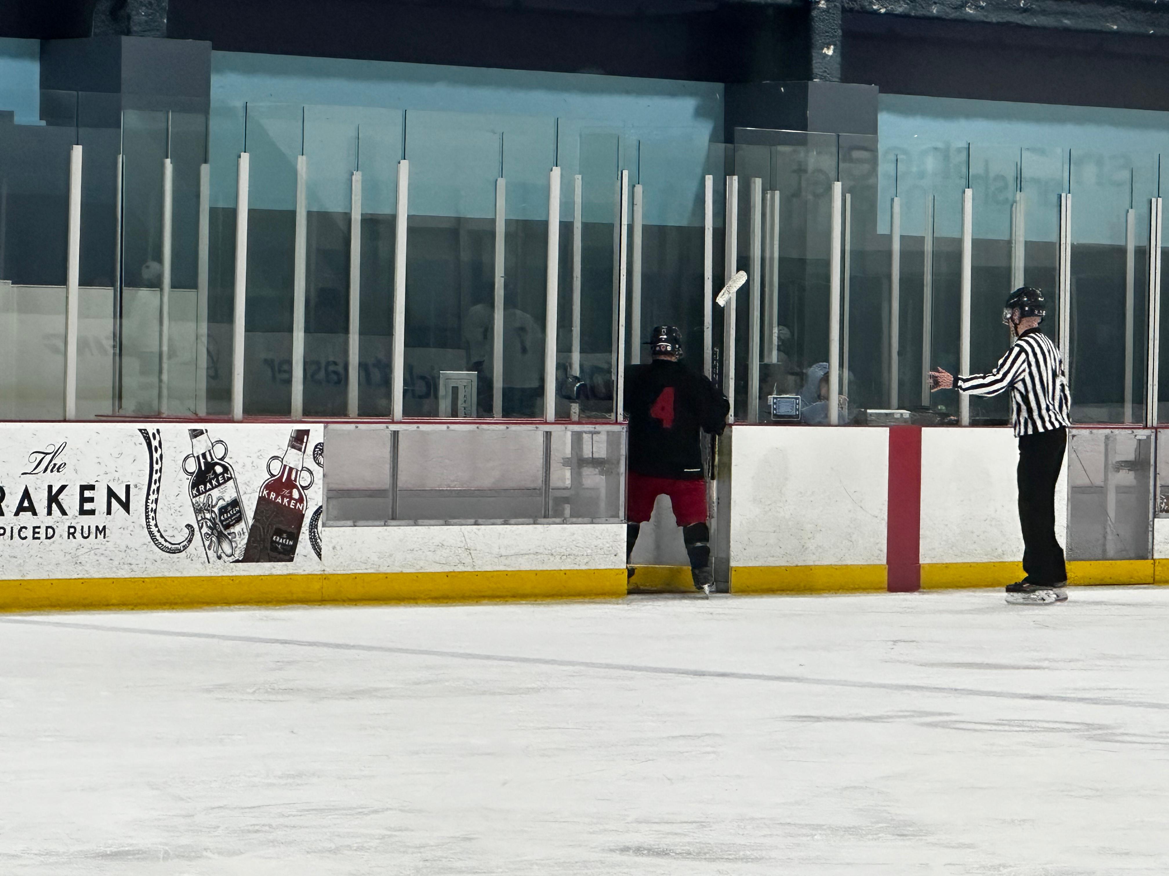 Not Sure player number 4 at the boards during a Kraken Hockey League game